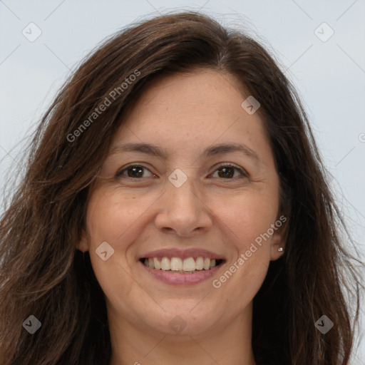 Joyful white adult female with long  brown hair and brown eyes