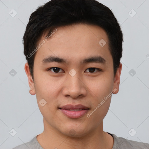 Joyful asian young-adult male with short  brown hair and brown eyes