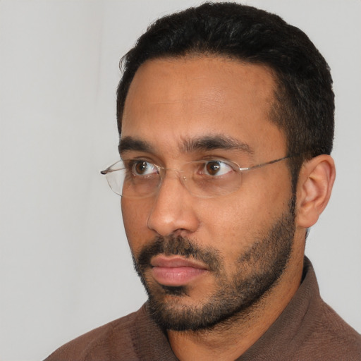Neutral black adult male with short  black hair and brown eyes