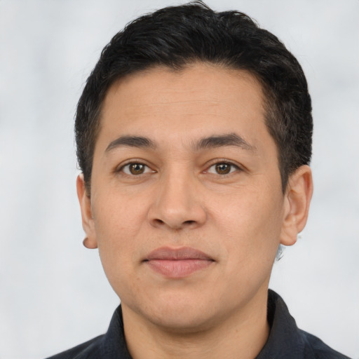 Joyful white young-adult male with short  black hair and brown eyes