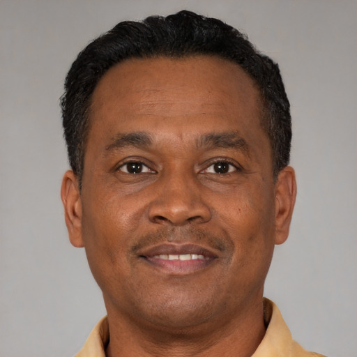 Joyful latino adult male with short  brown hair and brown eyes