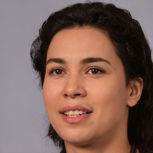 Joyful white young-adult female with medium  black hair and brown eyes