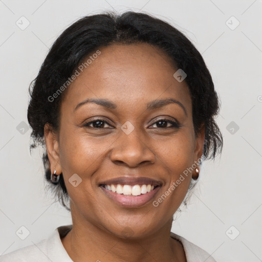 Joyful black adult female with medium  brown hair and brown eyes