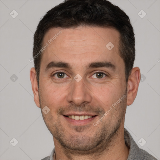 Joyful white adult male with short  brown hair and brown eyes