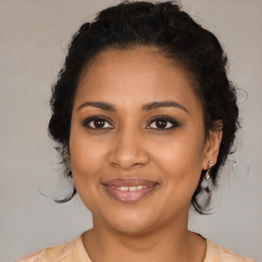 Joyful black young-adult female with medium  brown hair and brown eyes