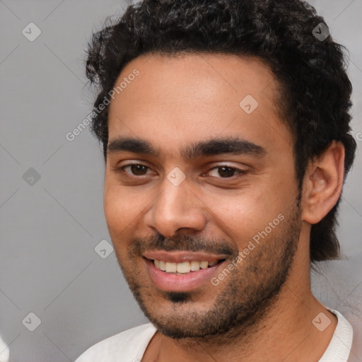 Joyful latino young-adult male with short  brown hair and brown eyes