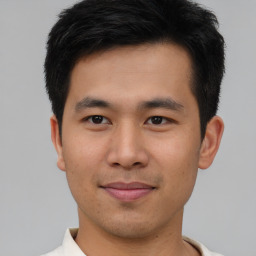 Joyful asian young-adult male with short  brown hair and brown eyes