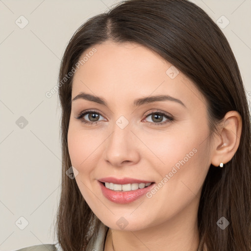 Joyful white young-adult female with long  brown hair and brown eyes