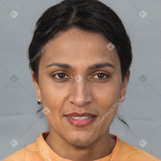 Joyful latino adult female with short  brown hair and brown eyes