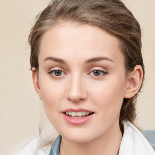 Joyful white young-adult female with medium  brown hair and blue eyes