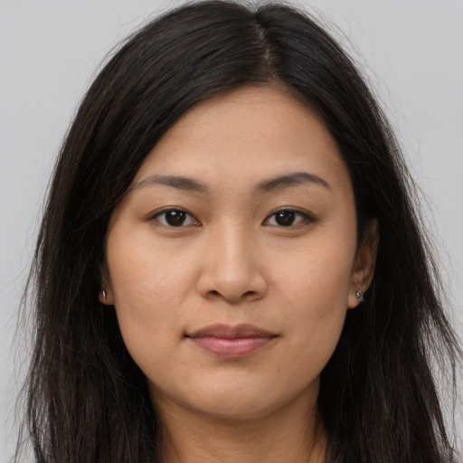 Joyful asian young-adult female with long  brown hair and brown eyes