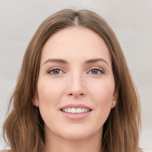 Joyful white young-adult female with long  brown hair and grey eyes