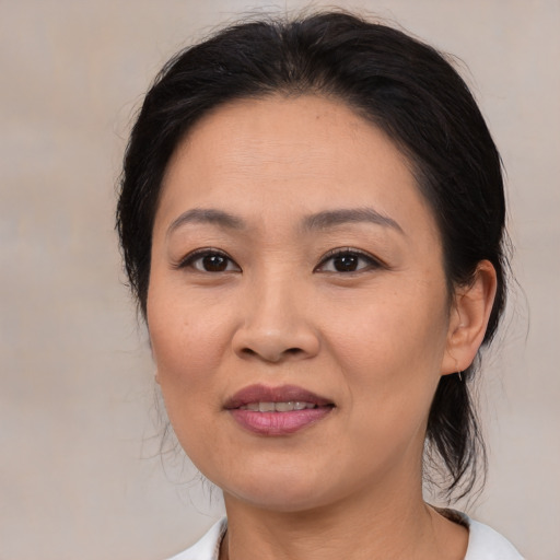 Joyful asian young-adult female with medium  brown hair and brown eyes