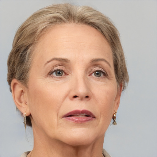 Joyful white adult female with medium  brown hair and grey eyes