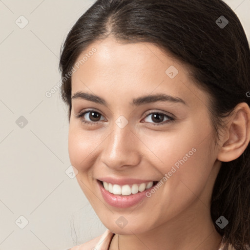 Joyful white young-adult female with long  brown hair and brown eyes