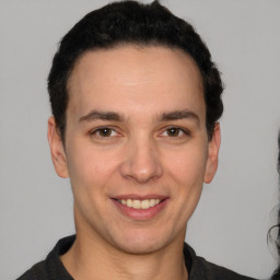 Joyful white young-adult male with short  black hair and brown eyes