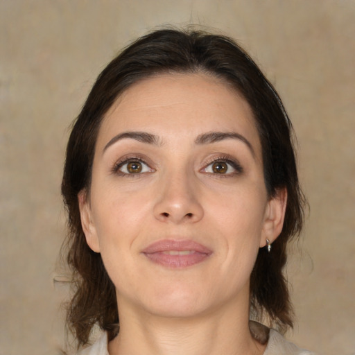 Joyful white adult female with medium  brown hair and brown eyes