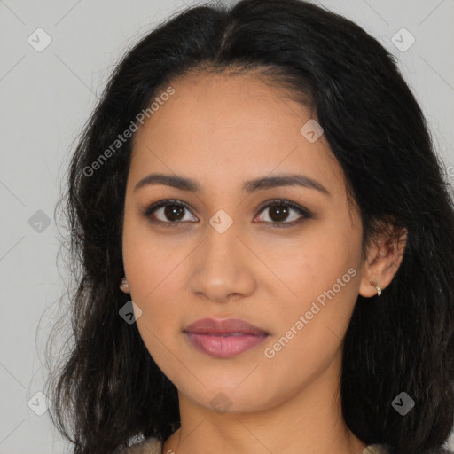 Joyful latino young-adult female with long  brown hair and brown eyes