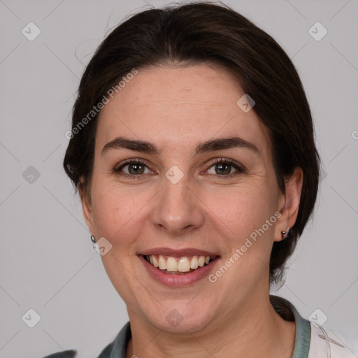 Joyful white adult female with medium  brown hair and grey eyes