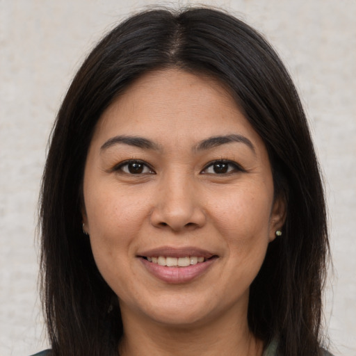 Joyful latino young-adult female with medium  brown hair and brown eyes