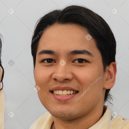 Joyful asian young-adult male with short  black hair and brown eyes