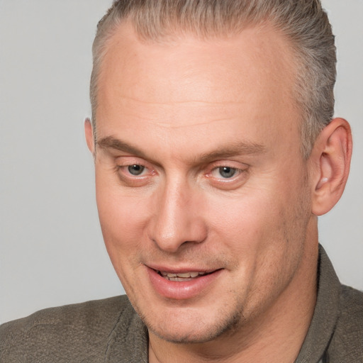 Joyful white adult male with short  brown hair and brown eyes