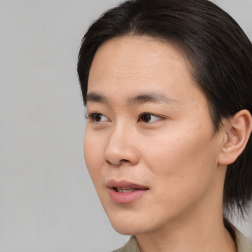 Joyful asian young-adult female with medium  brown hair and brown eyes