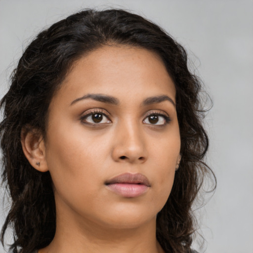 Neutral latino young-adult female with long  brown hair and brown eyes