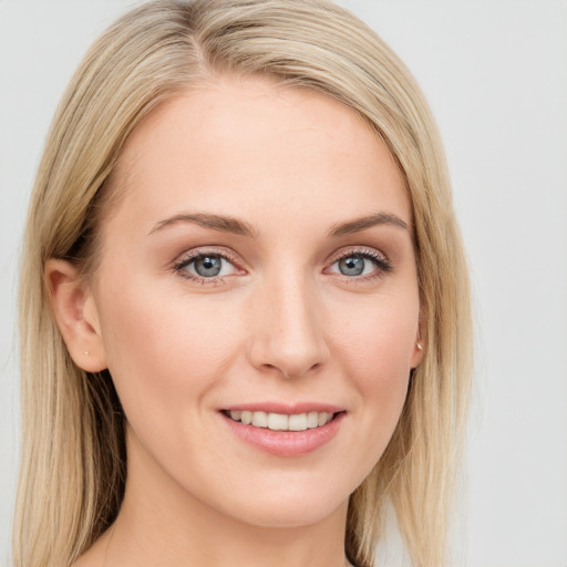 Joyful white young-adult female with long  brown hair and blue eyes