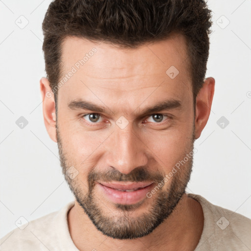 Joyful white young-adult male with short  brown hair and brown eyes