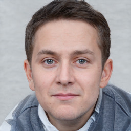 Joyful white adult male with short  brown hair and grey eyes