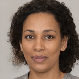 Joyful black adult female with medium  brown hair and brown eyes