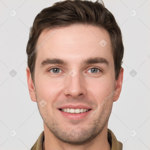 Joyful white young-adult male with short  brown hair and grey eyes