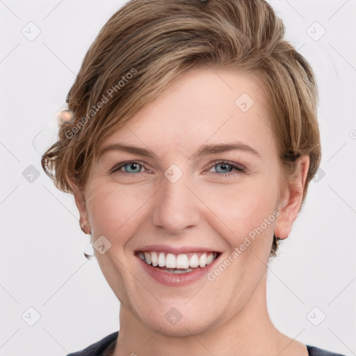 Joyful white young-adult female with medium  brown hair and grey eyes