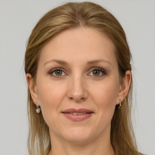 Joyful white adult female with long  brown hair and grey eyes