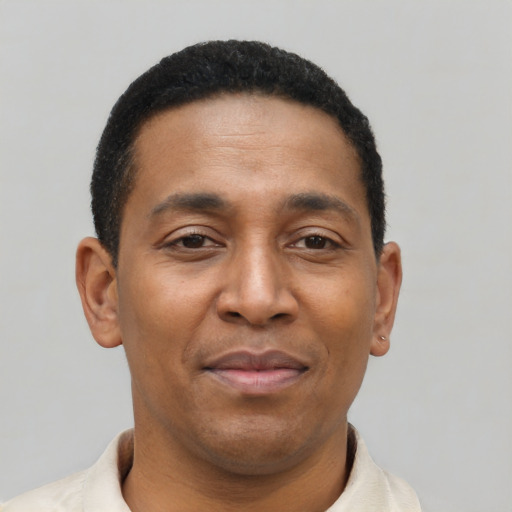 Joyful latino adult male with short  black hair and brown eyes