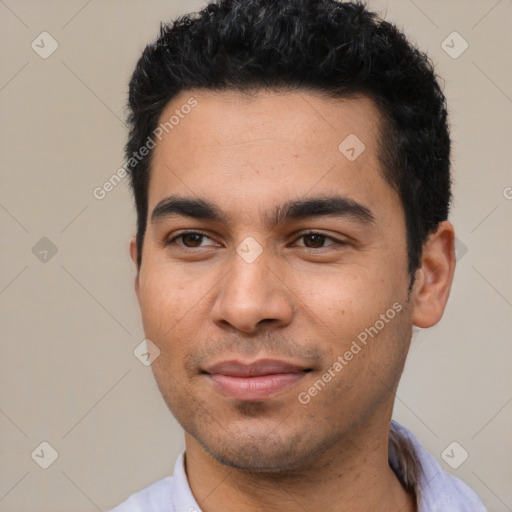 Joyful latino young-adult male with short  black hair and brown eyes