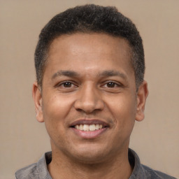 Joyful latino adult male with short  brown hair and brown eyes