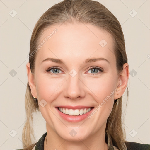 Joyful white young-adult female with long  brown hair and blue eyes