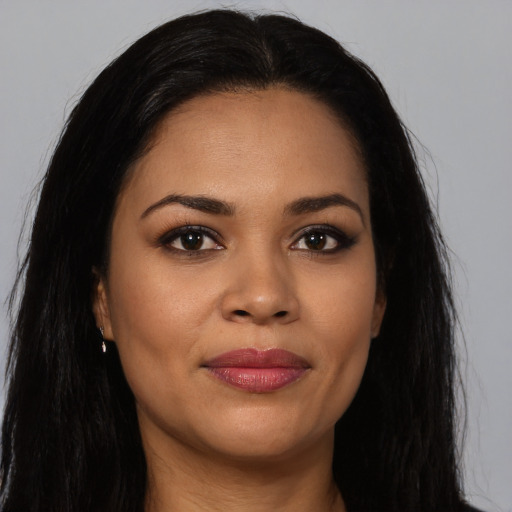 Joyful latino young-adult female with long  brown hair and brown eyes