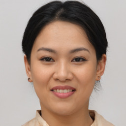 Joyful asian young-adult female with short  brown hair and brown eyes