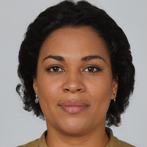 Joyful latino adult female with short  brown hair and brown eyes