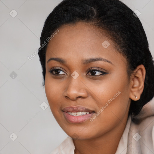 Joyful black young-adult female with short  black hair and brown eyes