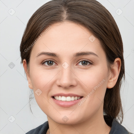 Joyful white young-adult female with medium  brown hair and grey eyes