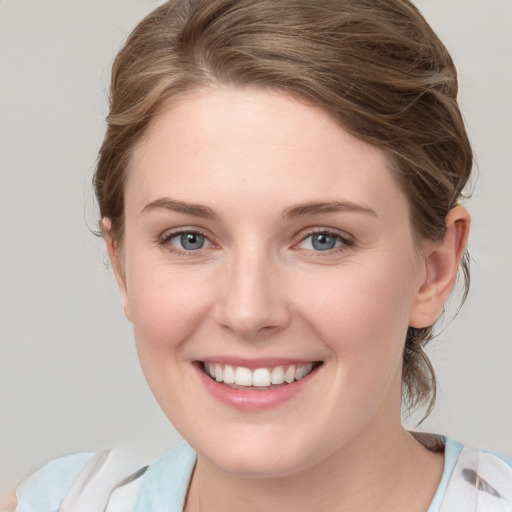 Joyful white young-adult female with medium  brown hair and blue eyes