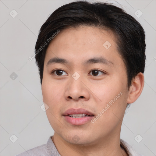 Joyful asian young-adult male with short  brown hair and brown eyes