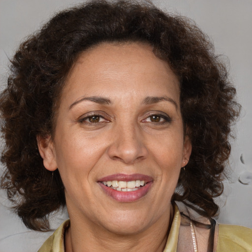 Joyful black adult female with medium  brown hair and brown eyes