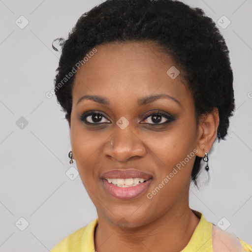 Joyful black young-adult female with short  black hair and brown eyes