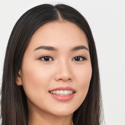 Joyful asian young-adult female with long  brown hair and brown eyes