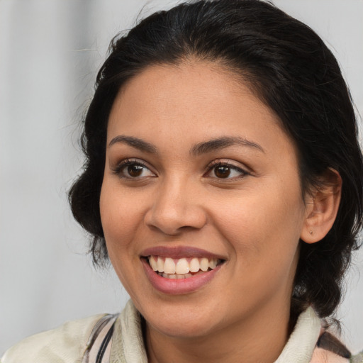 Joyful latino young-adult female with medium  brown hair and brown eyes